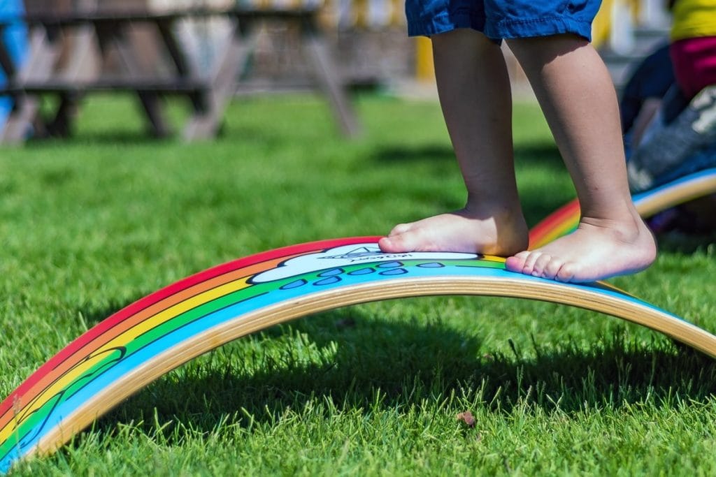 curvy-balance-board-alwahwdusur-brand-wooden-handcrafted-toys-custom-made-child-trying-take-steps-to-balance