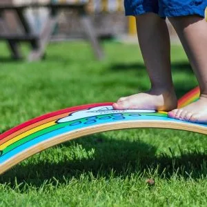 curvy-balance-board-alwahwdusur-brand-wooden-handcrafted-toys-custom-made-child-trying-take-steps-to-balance